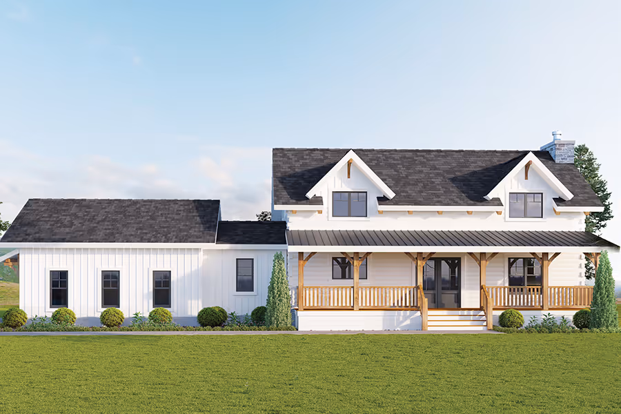 A charming two-story farmhouse with a white exterior and a black roof, featuring a large front porch with wooden railings. Lush green grass surrounds the house, contrasted by tall trees in the background.