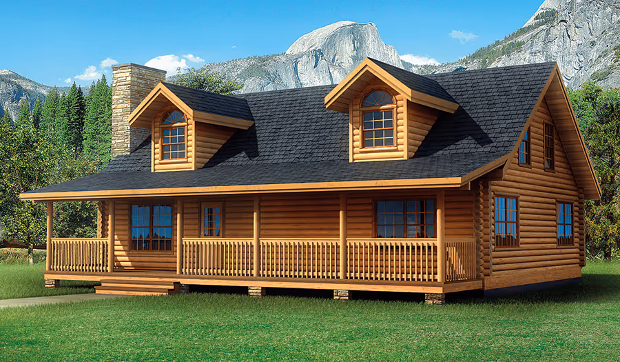 A picturesque wooden cabin with a wrap-around porch, featuring a sloped roof and two dormer windows. It is surrounded by tall green trees, with majestic mountains in the background under a clear blue sky.