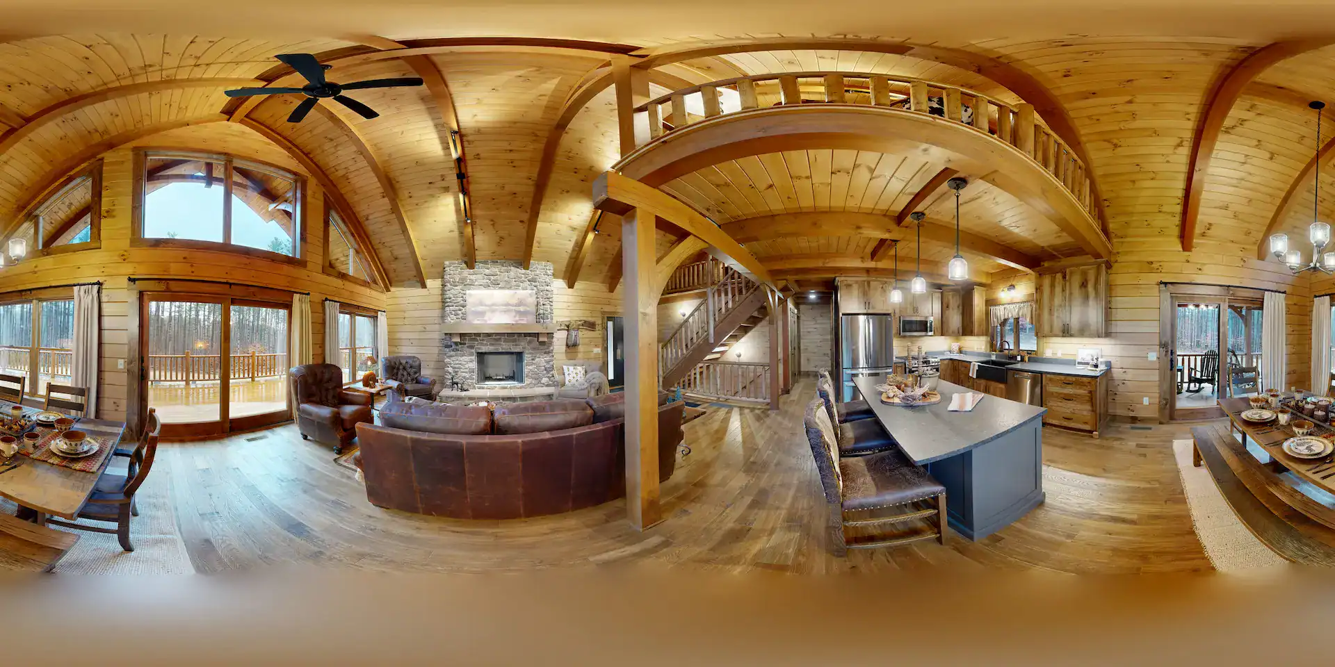 Cozy log home interior with fireplace, large windows, and wooden accents.
