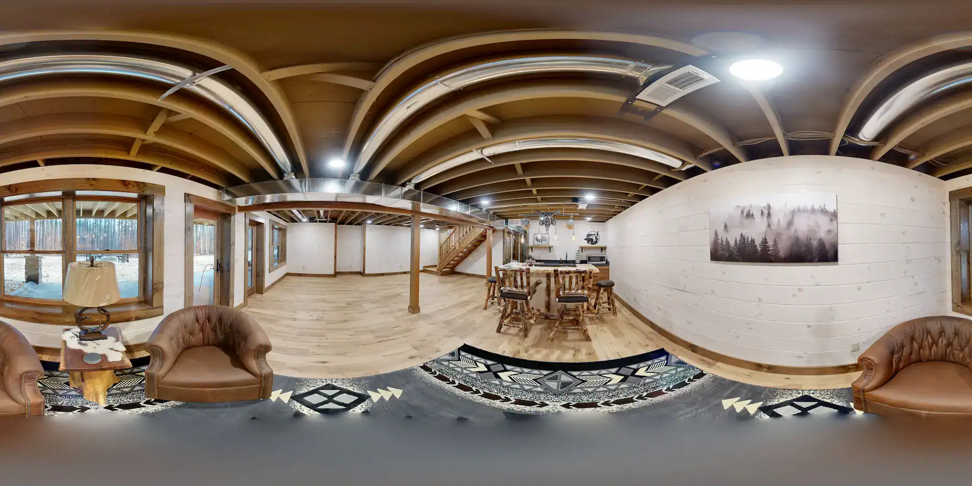 Spacious interior of Hochstetler Log Homes with living and dining areas.