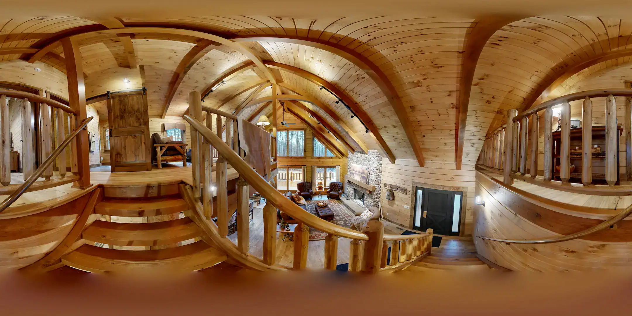 Cozy log home interior with wooden beams and staircase.