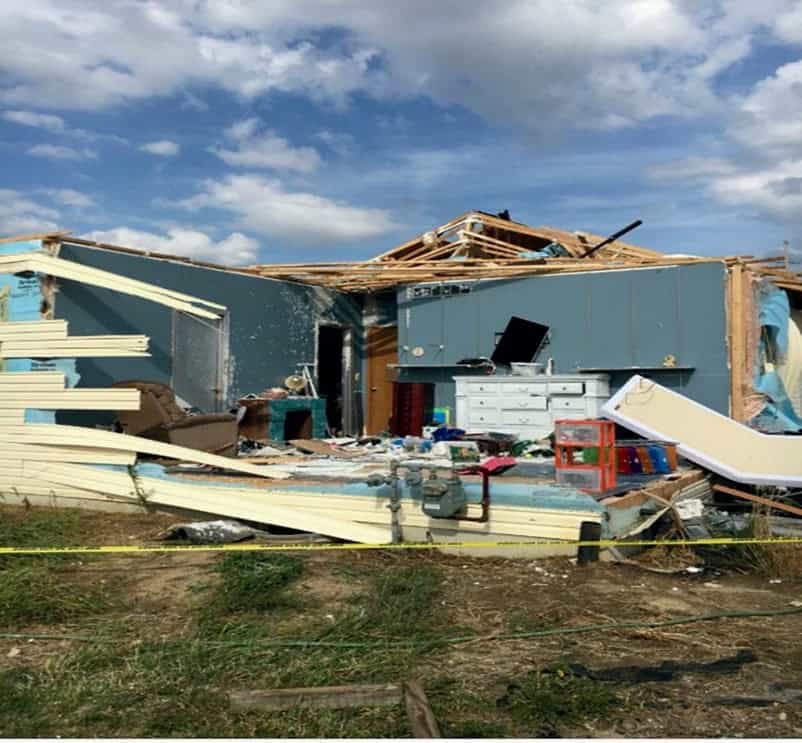 Conventional home damaged by severe weather, illustrating structural vulnerability during extreme conditions