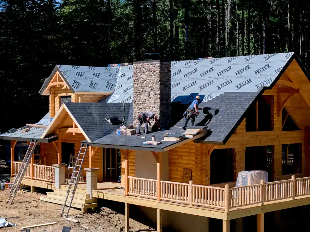 Log home with roofing and windows installed and the exterior closed in