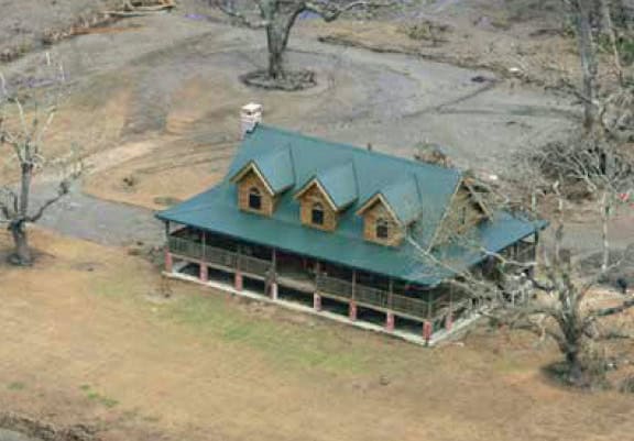 Log home still standing after severe weather damaged surrounding conventional homes